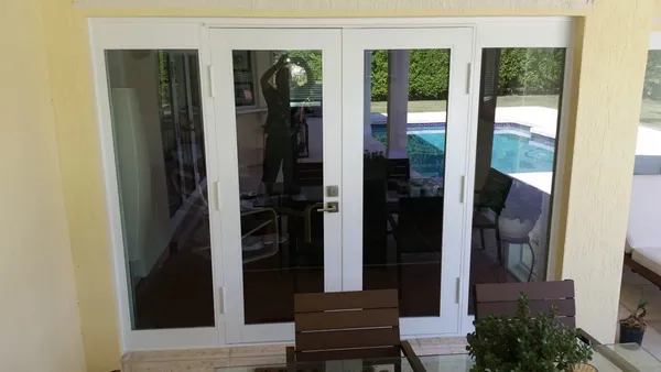 Impact windows and doors - opening doors and windows with white frame.