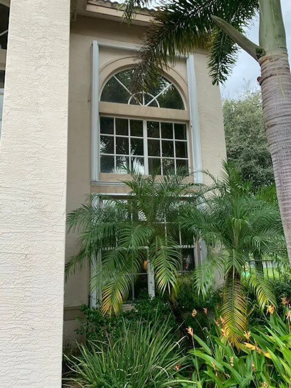 Front of home tall window - window repair service in boca concept image