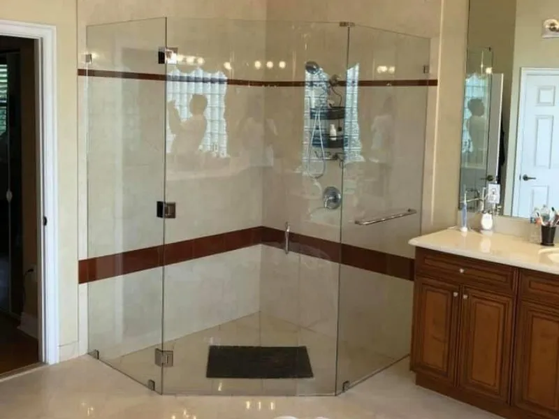 frameless showers in a private bathroom with marble tile